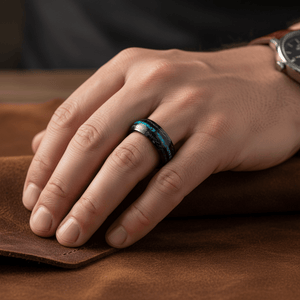 ANTONAS — Lifestyle photo on hand — men's tungsten wedding ring.