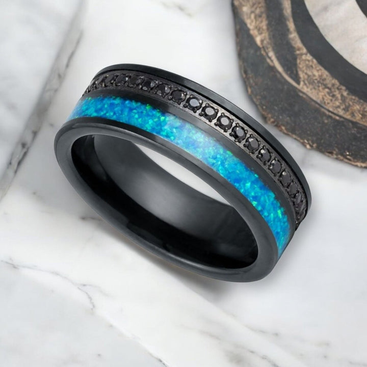 Sophisticated AQUORION tungsten ring featuring black diamond-simulated CZ and opal.