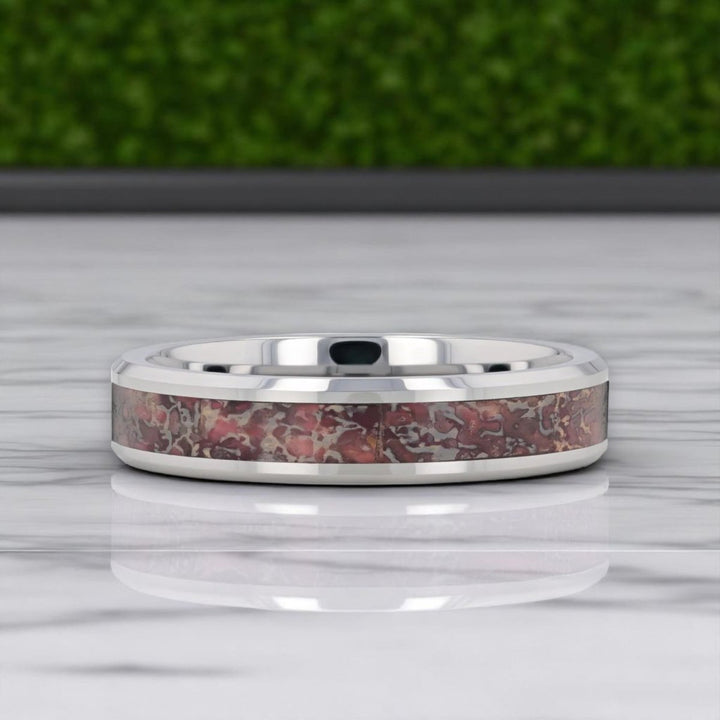 ARCHEAN pink dinosaur bone ring displayed at angle to show shine and detail