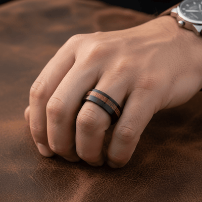 ARCHIE — Lifestyle photo on hand — men's tungsten wedding ring.