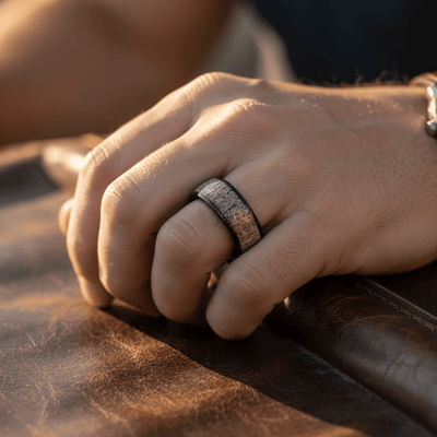ARNEB — Lifestyle photo on hand — men's tungsten wedding ring.