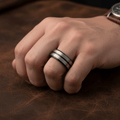 ASHCHIL — Lifestyle photo on hand — men's tungsten wedding ring.