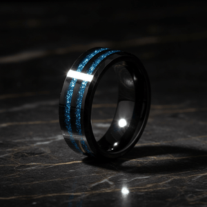 ASHEN — Luxury 3/4 angle on dark marble — men's tungsten wedding ring.