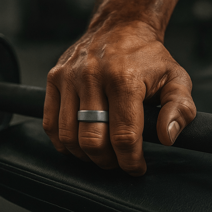 Men’s titanium wedding band with meteorite pattern on a hand – Aydins Jewelry