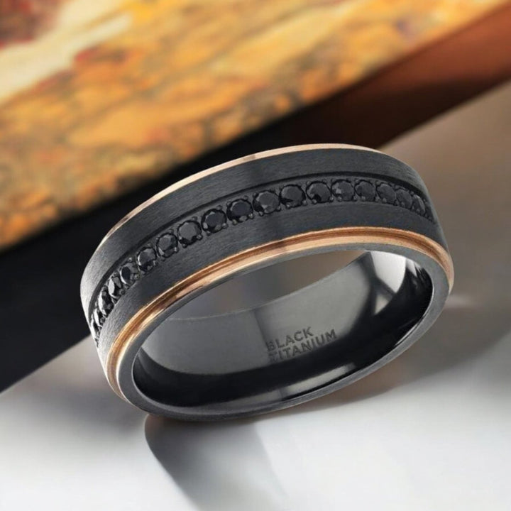 ASTRO black titanium wedding band featuring brushed finish, rose gold-plated edges, and black sapphires - Aydins Jewelry.