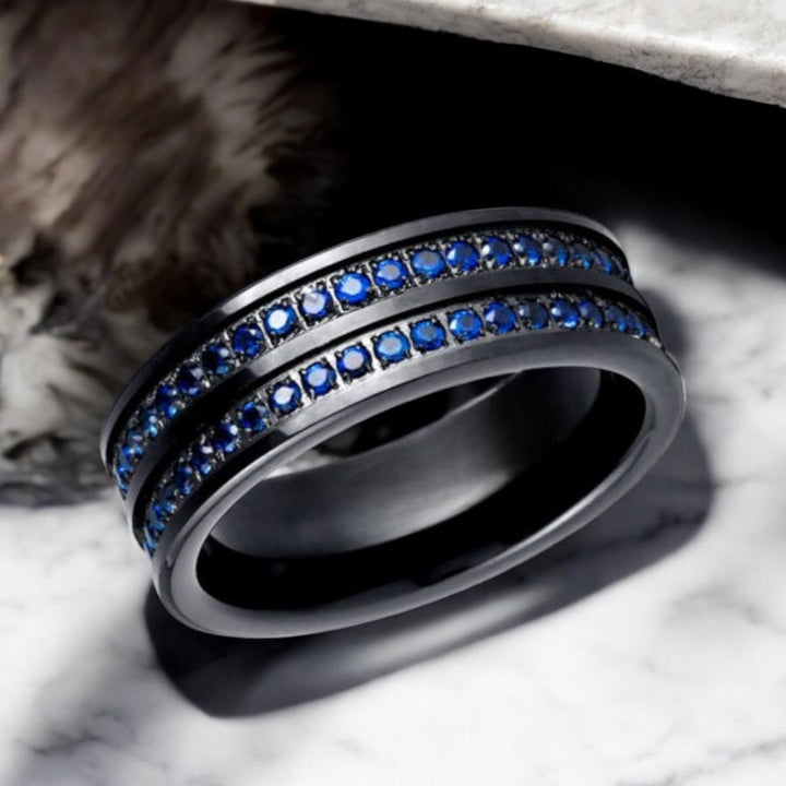 Close-up of AZURON ring showcasing double rows of diamond-simulated blue CZ stones.