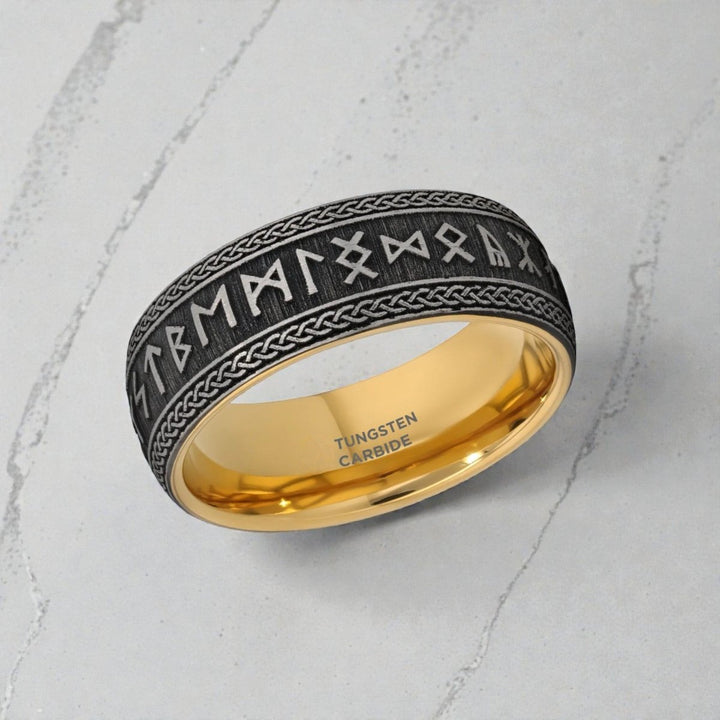 Close up of deep runes engraved around matte black tungsten band