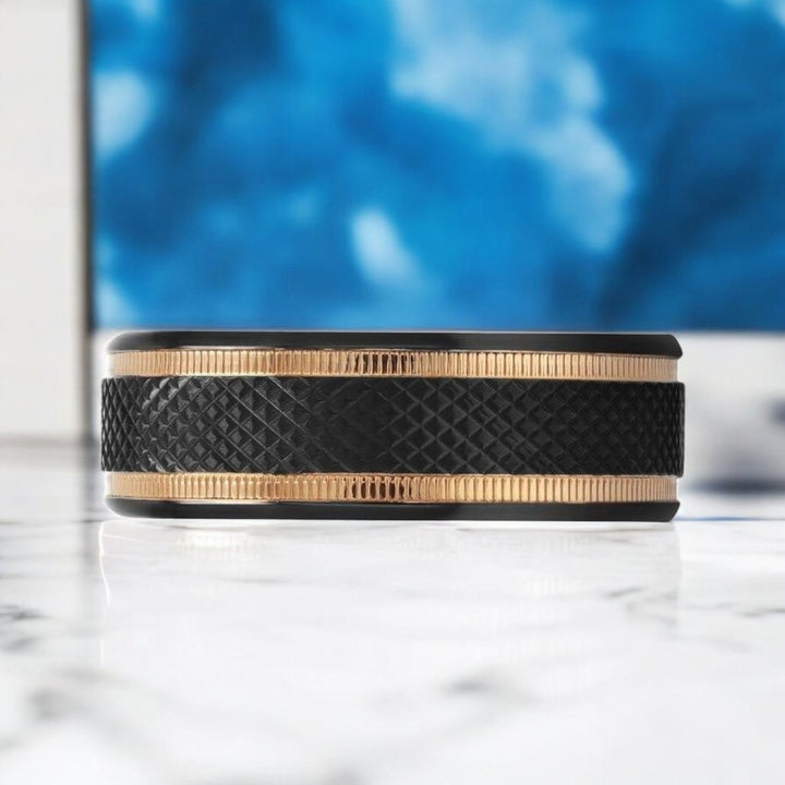 Modern black titanium ring featuring a diamond pattern finish and luxurious gold milgrain grooves.