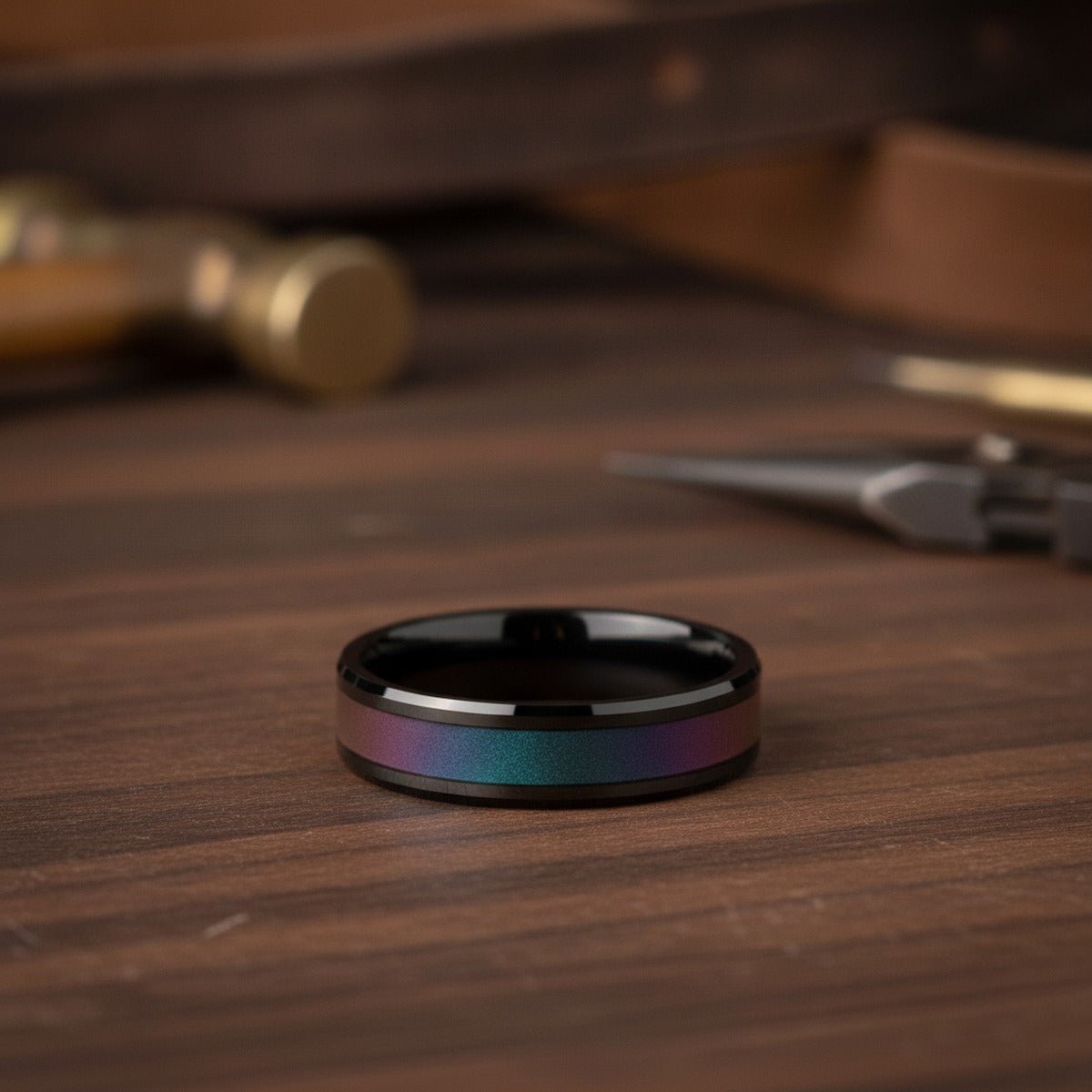 Aydins BARRACUDA | Black Ceramic Ring, Color Changing Inlay lifestyle scene, dark walnut workshop