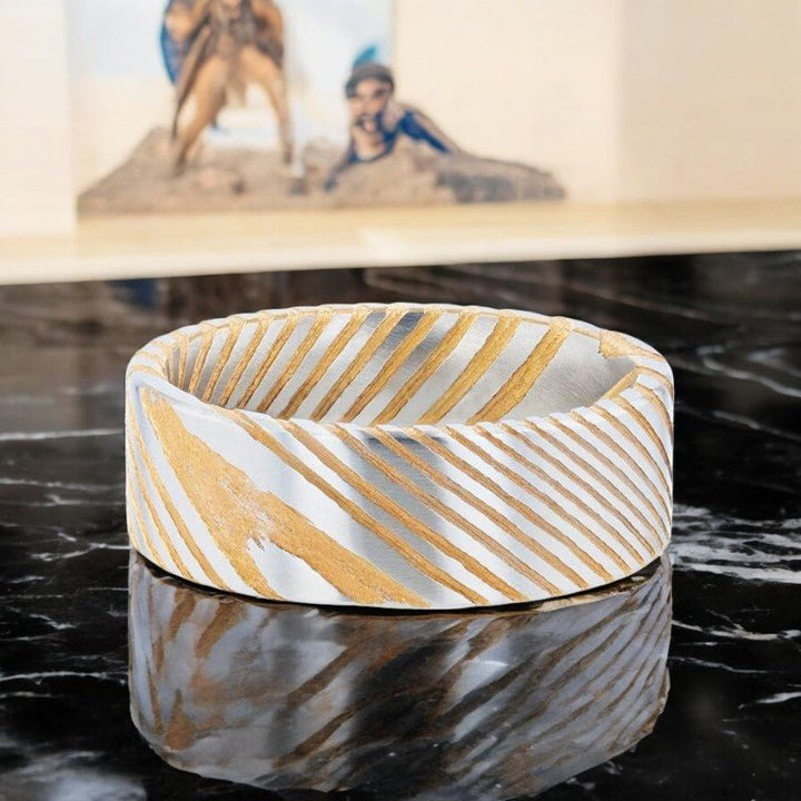 Gold color Damascus steel wedding band with etched design, available in 6mm and 8mm widths.