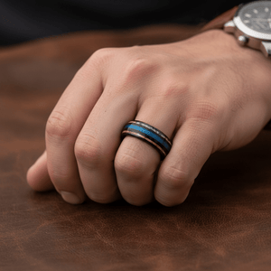 BLUEBARK — Lifestyle photo on hand — men's tungsten wedding ring.