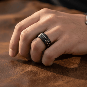 BOSTIN — Lifestyle photo on hand — men's tungsten wedding ring.