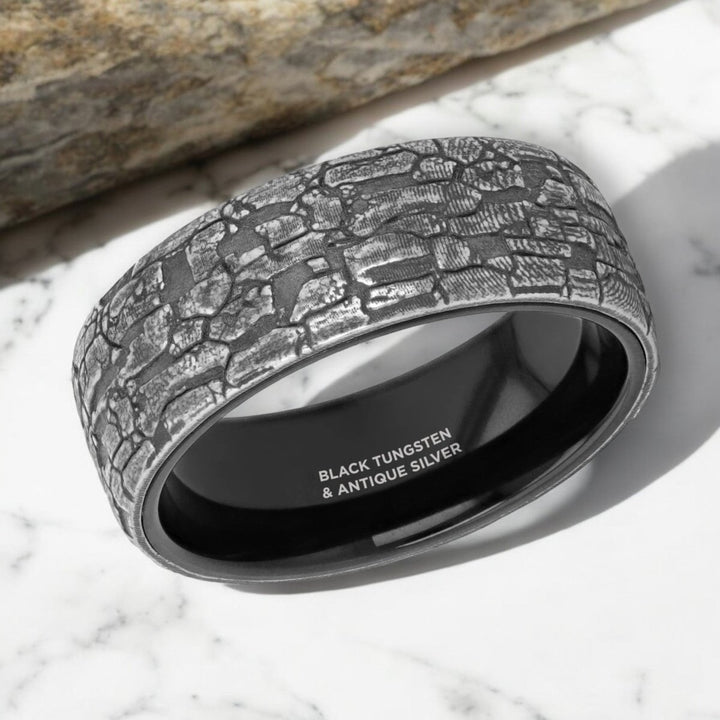 Side view of the BROOKSTONE 8mm Black Tungsten Ring featuring a textured silver inlay.