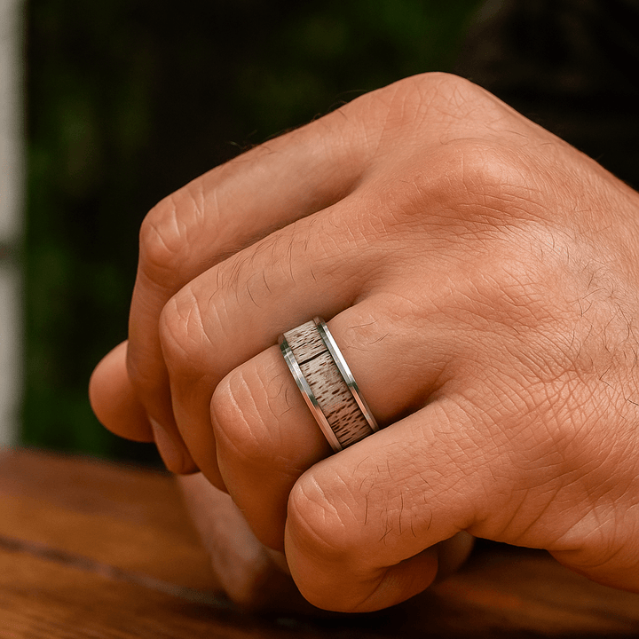 Close-up of natural antler grain in BUCK wedding band On Hand Ring Finger