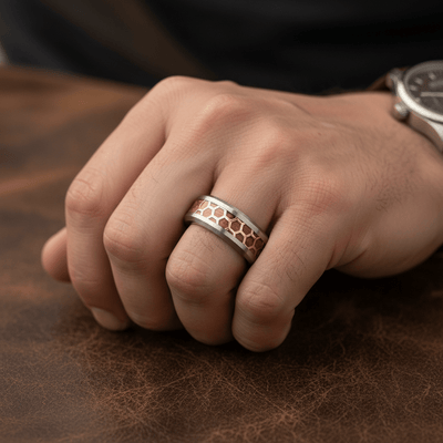 BUZZARD — Lifestyle photo on hand — men's tungsten wedding ring.