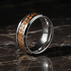 BUZZARD — Luxury 3/4 angle on dark marble — men's tungsten wedding ring.