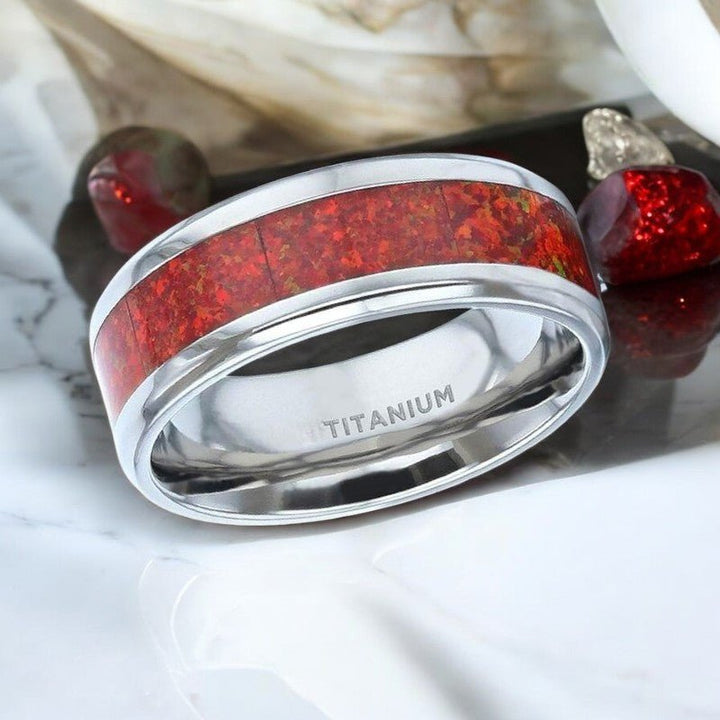 CASSIOPEIA titanium wedding band featuring vibrant red opal inlay and sleek beveled edges - Aydins Jewelry.