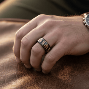 CASTORLAND — Lifestyle photo on hand — men's tungsten wedding ring.