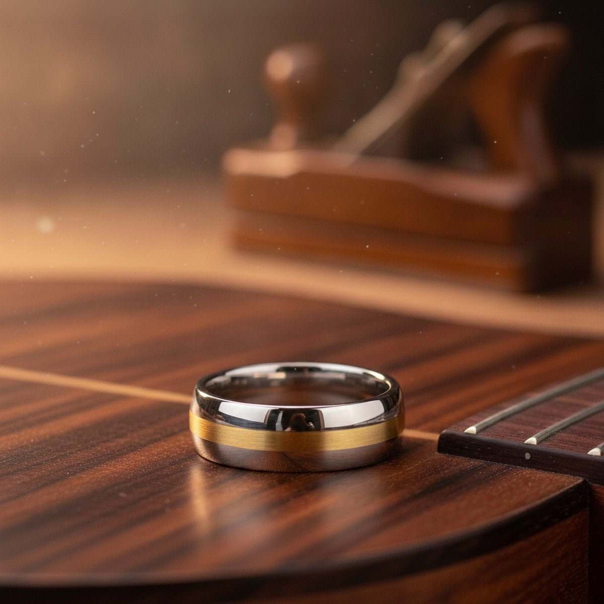 Aydins CENTURION | Silver Tungsten Ring, 14k Yellow Gold Stripe Inlay, Domed lifestyle scene, luthier shop
