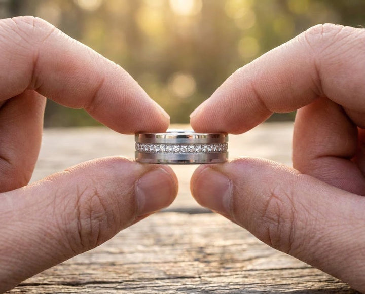 Holding the ring between two fingers 8mm CEPHEUS Silver Tungsten Ring - Eternity Wedding Band with CZ Stones