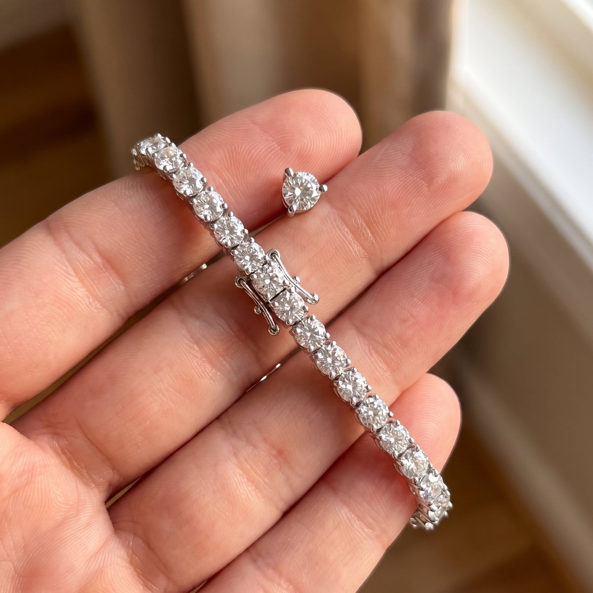 Classic Three Prong Tennis Bracelet 925 silver lab grown diamond bracelet held in hand lifestyle close-up photo