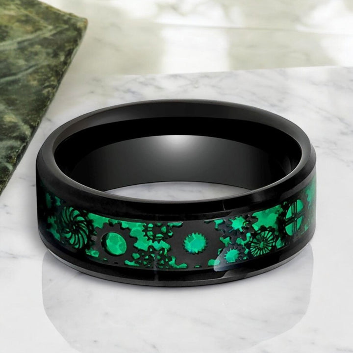 Top view of COGSPRING Black Tungsten Ring with vibrant green carbon fiber and steampunk motif.