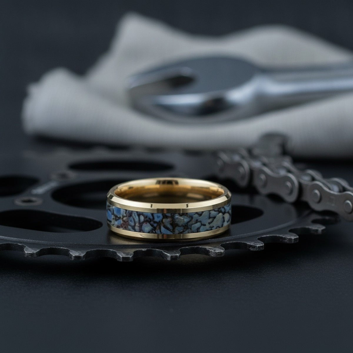 Aydins CORYTHOSAURUS |  Blue Dino Bone Inlaid 14k Yellow Gold lifestyle scene, cycling workshop