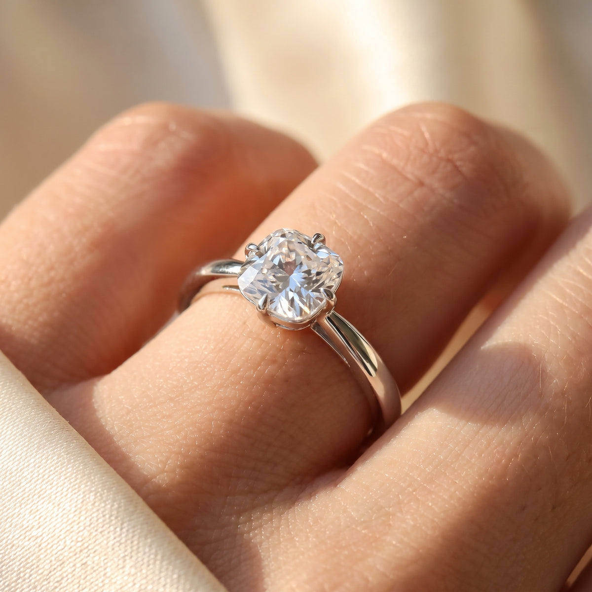 Cushion lab-grown diamond solitaire engagement ring, 925 Sterling Silver, on-finger close-up