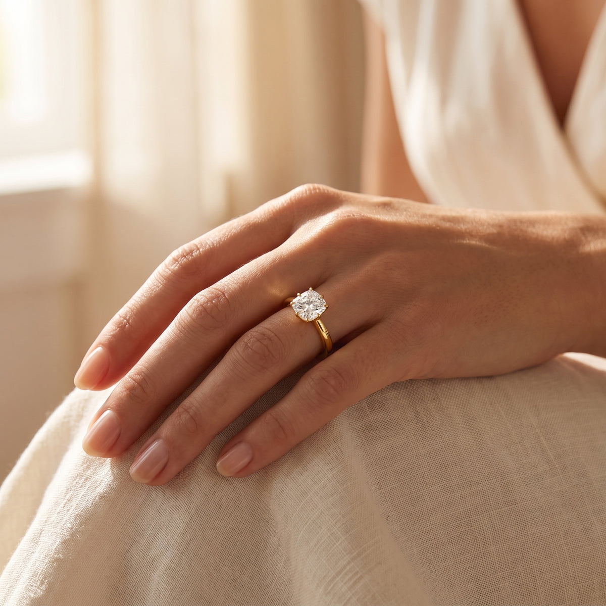 Cushion lab-grown diamond solitaire engagement ring, Yellow Gold, lifestyle photograph