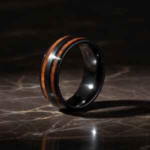 DAPPER — Luxury 3/4 angle on dark marble — men's tungsten wedding ring.