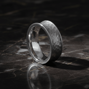 DECIUS — Luxury 3/4 angle on dark marble — men's tungsten wedding ring.