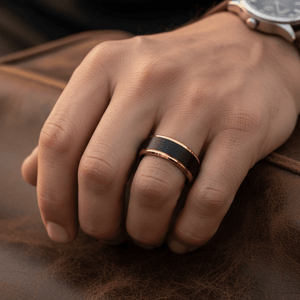 DEIMOS — Lifestyle photo on hand — men's tungsten wedding ring.