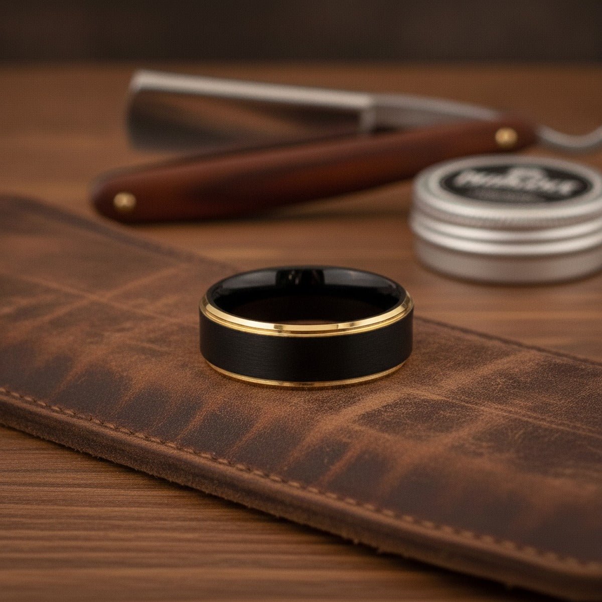 Aydins DEIMOS | Brushed Black Tungsten Yellow Gold Stepped Edge Wedding Ring 8mm | Aydins lifestyle scene, barber strop