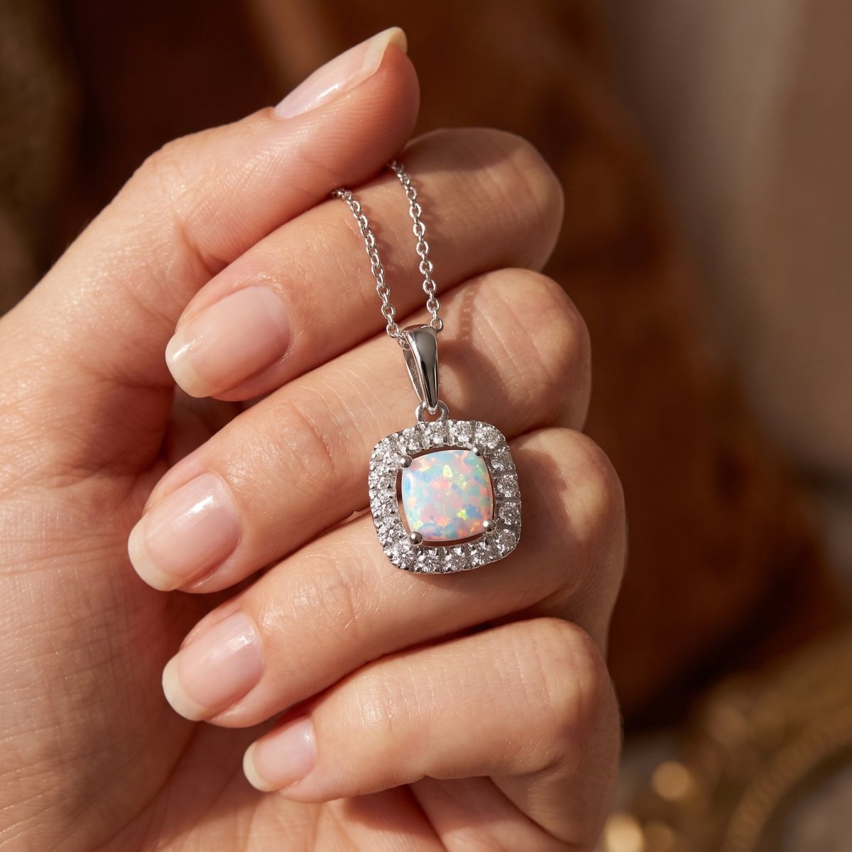 Diamond and Lab Opal Necklace 925 silver lab grown diamond necklace held in hand lifestyle close-up photo