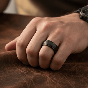 DION — Lifestyle photo on hand — men's tungsten wedding ring.