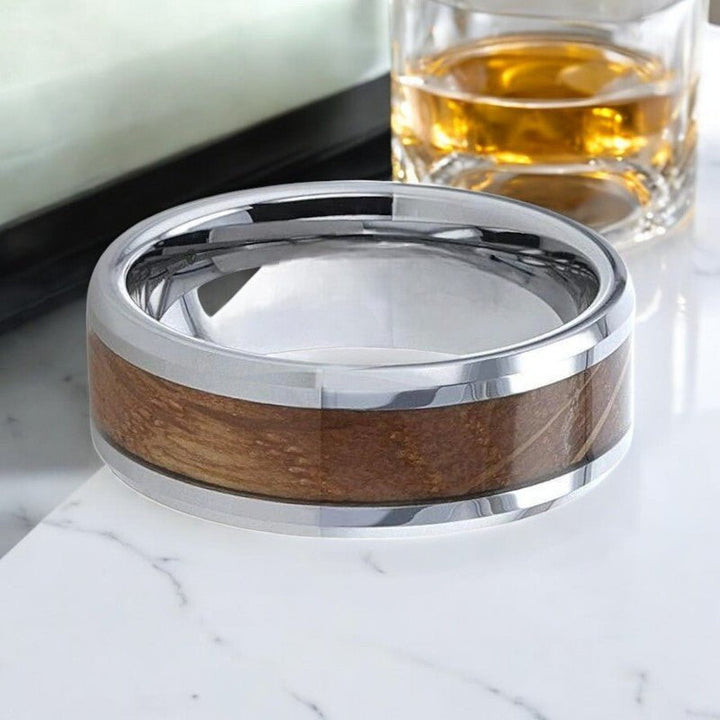 DISTILLED silver tungsten ring with whiskey barrel inlay and polished beveled finish by Aydins Jewelry.