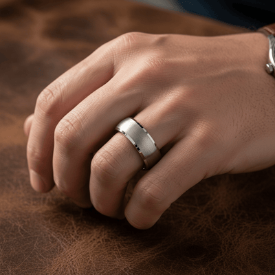 DOMESCAPE — Lifestyle photo on hand — men's tungsten wedding ring.
