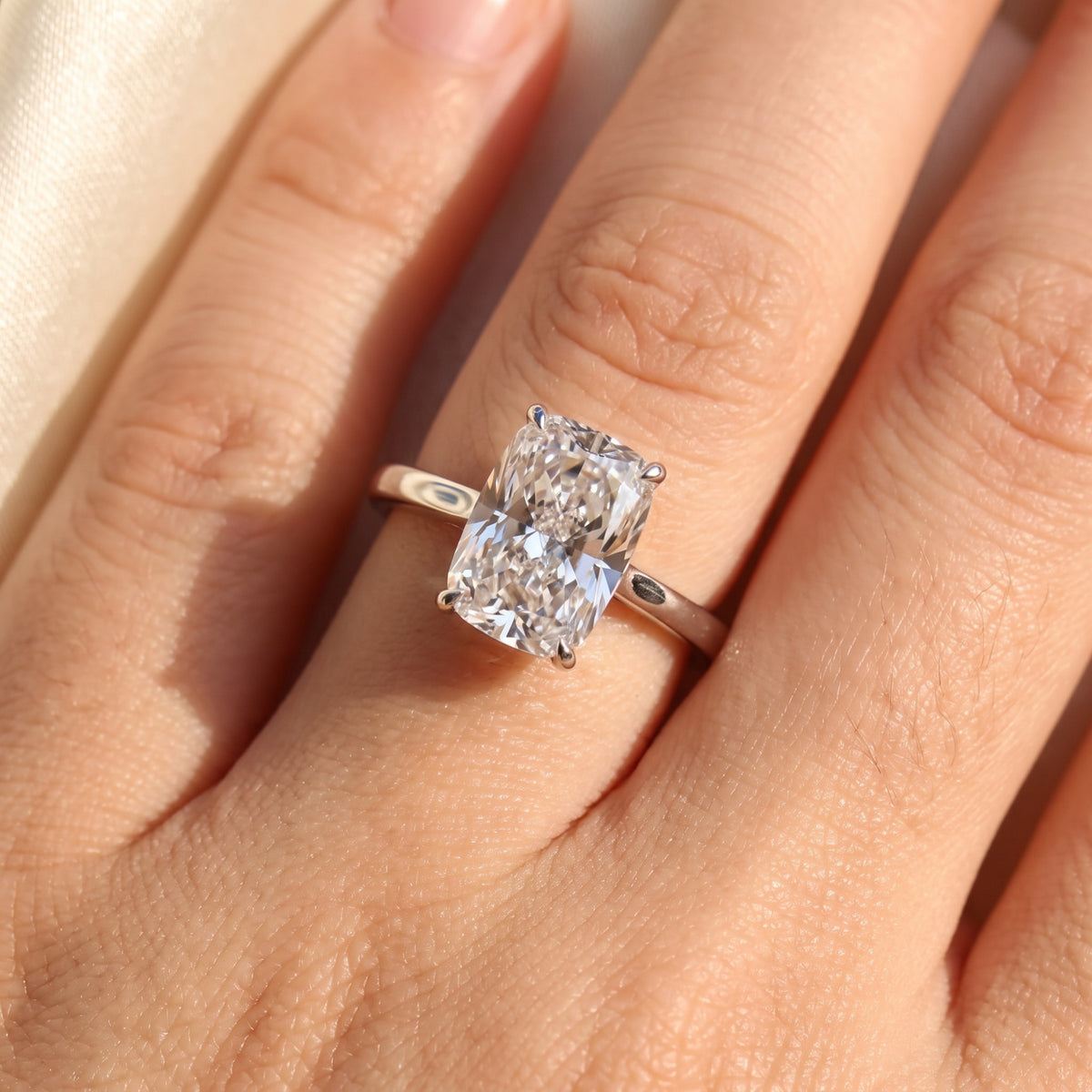 Elongated Cushion lab-grown diamond solitaire engagement ring, 925 Sterling Silver, on-finger close-up