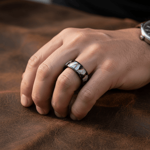 ELITIS — Lifestyle photo on hand — men's tungsten wedding ring.