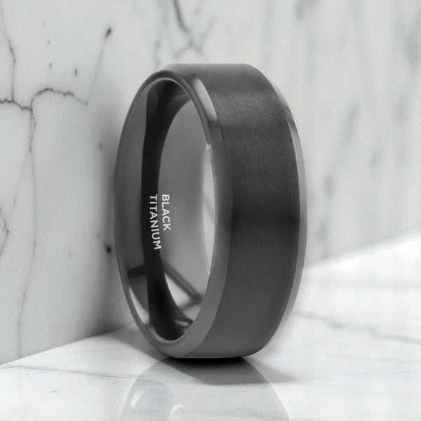 Front view of ELYSIAN black titanium ring with brushed center and polished edges