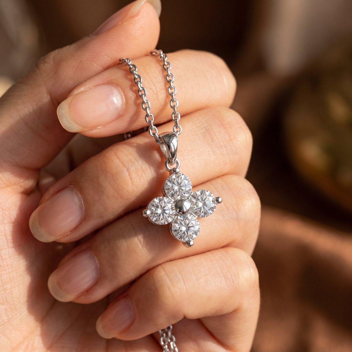 Four Stone Round Diamond Pendant With Chain 925 silver lab grown diamond pendant held in hand lifestyle close-up photo