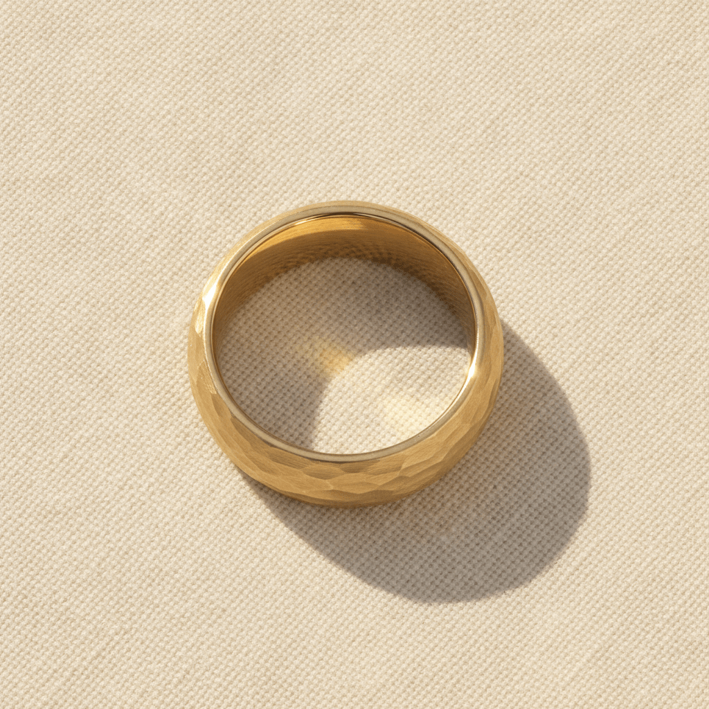 GILDUR gold-plated tungsten wedding band with domed hammered finish macro detail overhead flat lay