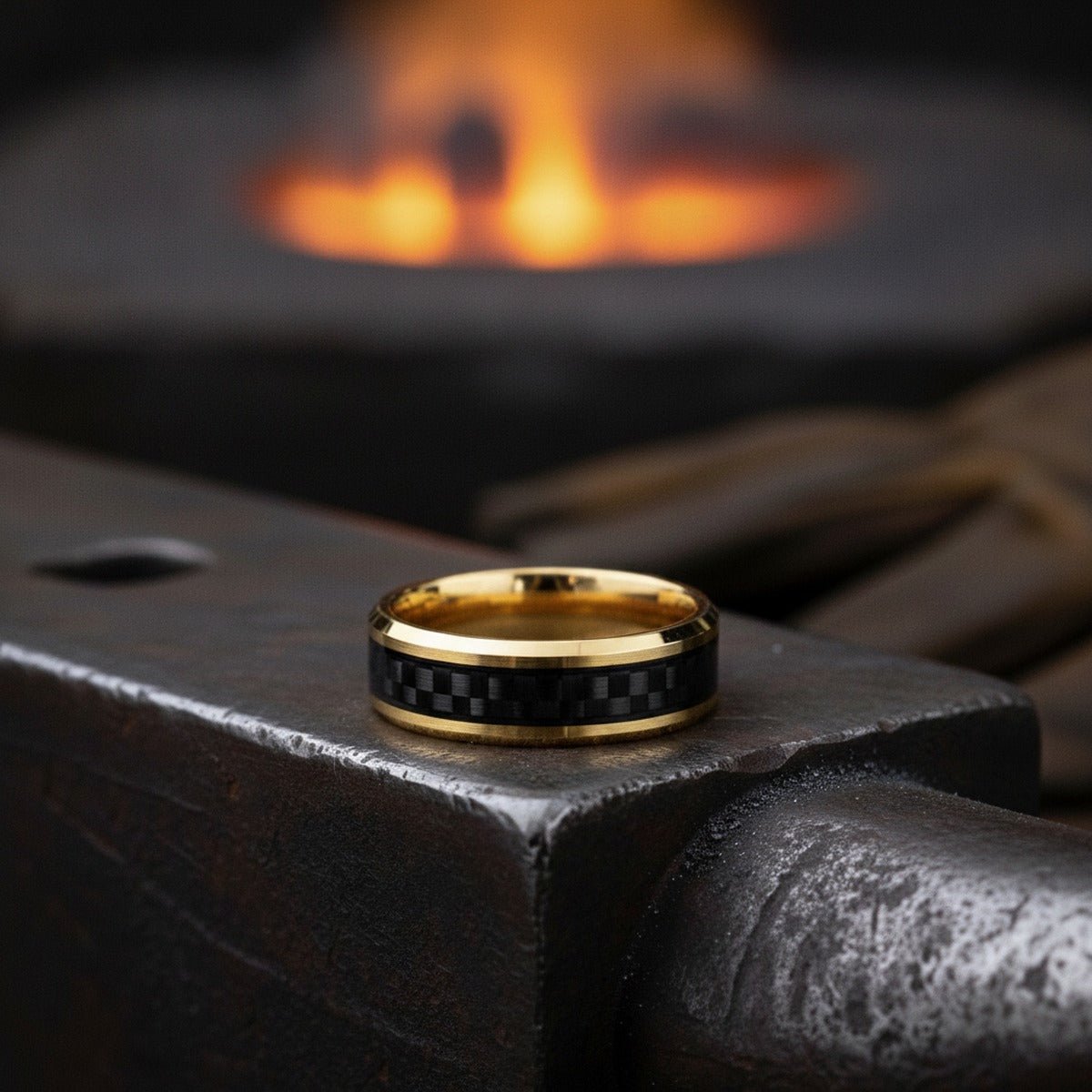 Aydins GILDWING | Polished Yellow Gold Tungsten Forged Carbon Fiber Beveled Ring 8mm lifestyle scene, blacksmith forge