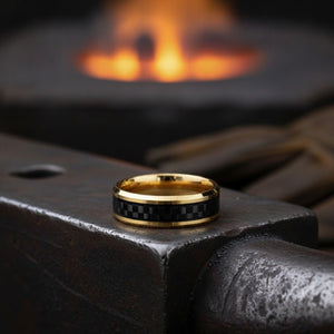 Aydins GILDWING | Polished Yellow Gold Tungsten Forged Carbon Fiber Beveled Ring 8mm lifestyle scene, blacksmith forge