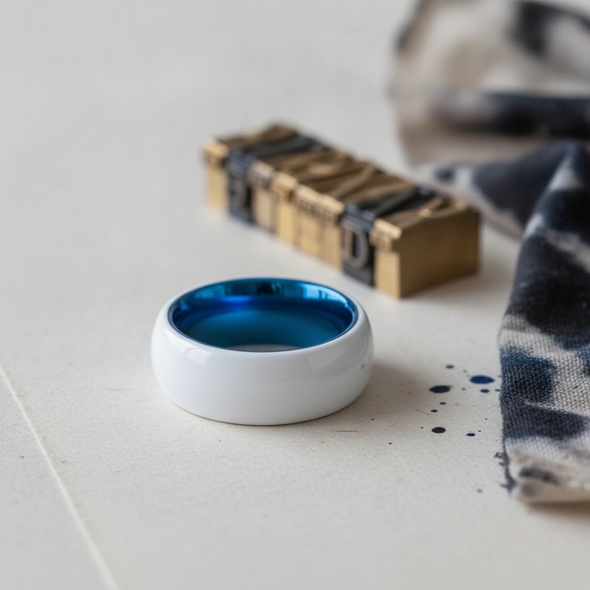 Aydins GLAZE | Blue Tungsten Ring, White Ceramic Ring, Domed lifestyle scene, letterpress print