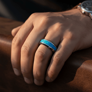 GLEAMING — Lifestyle photo on hand — men's tungsten wedding ring.