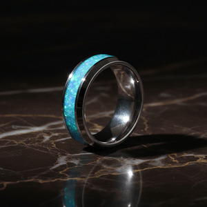 GLEAMING — Luxury 3/4 angle on dark marble — men's tungsten wedding ring.