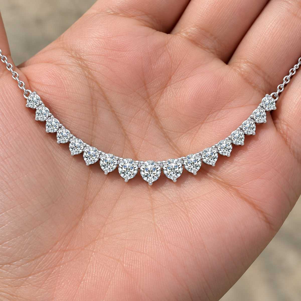 Graduated Diamond Necklace With Chain, silver, lab grown diamonds, resting on a hand
