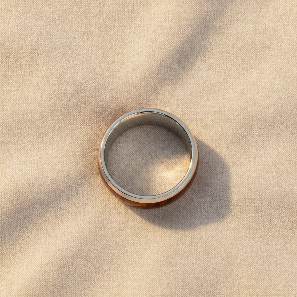 GROVE silver tungsten carbide wedding band with redwood inlay running around the band and polished edges macro detail overhead flat lay