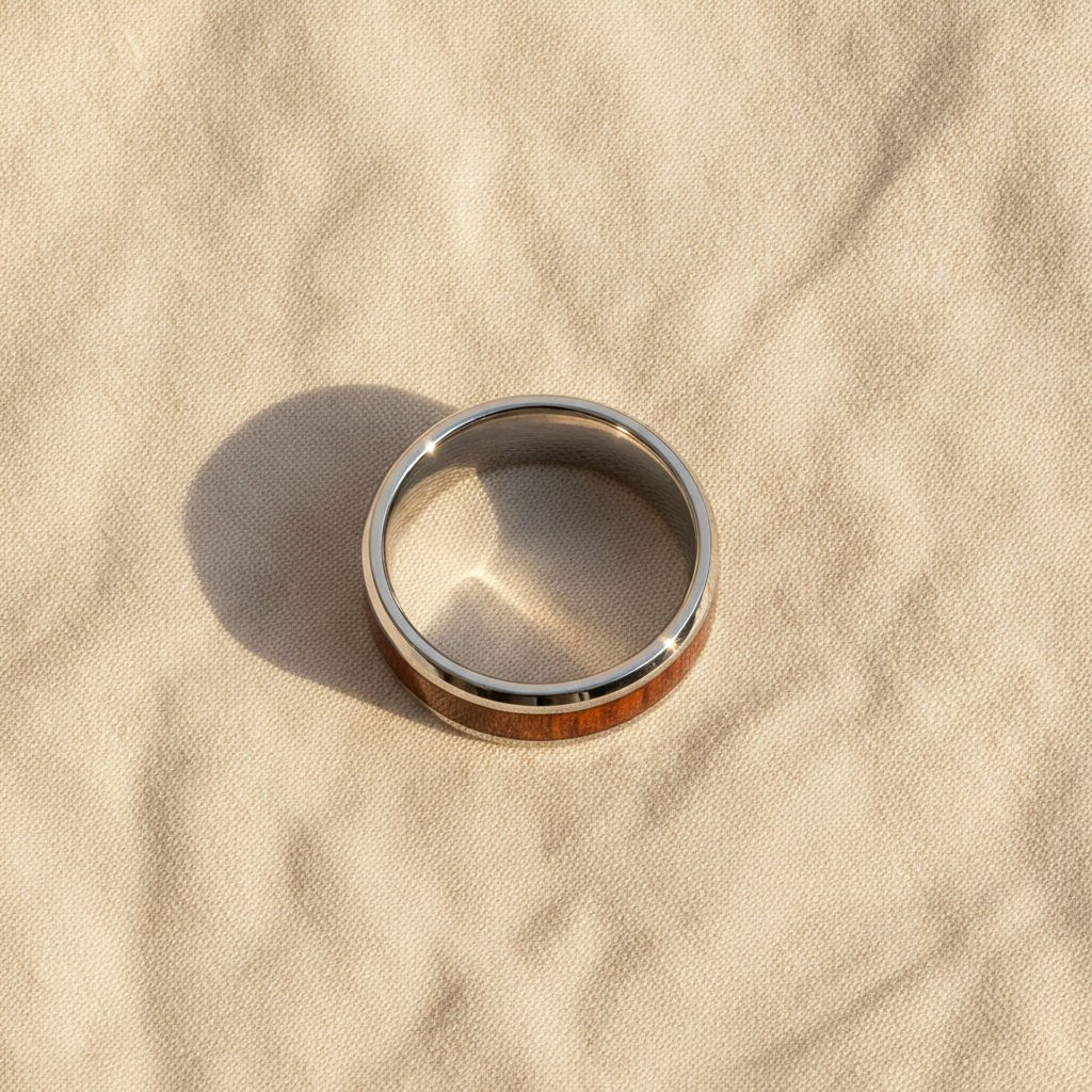 HALIFAX silver tungsten wedding band with black walnut wood inlay running around the band and polished beveled edges macro detail overhead flat lay